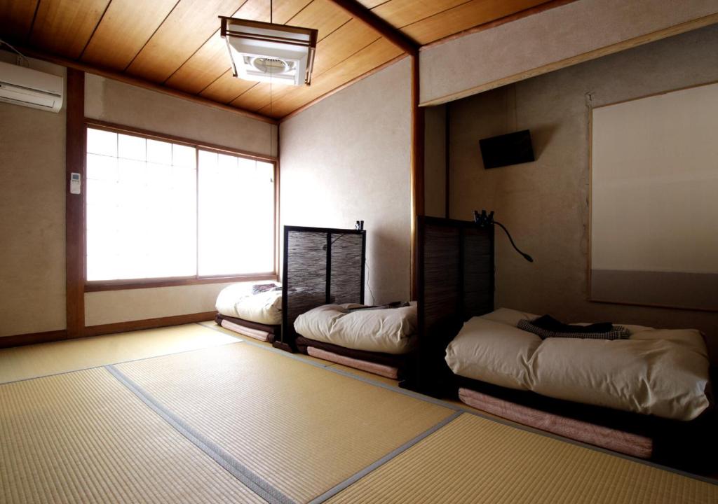Postel nebo postele na pokoji v ubytování Izumo guesthouse itoan