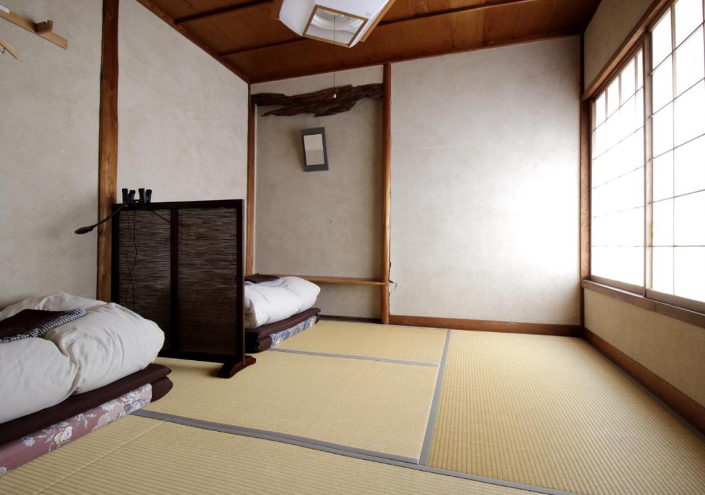 Postel nebo postele na pokoji v ubytování Izumo guesthouse itoan