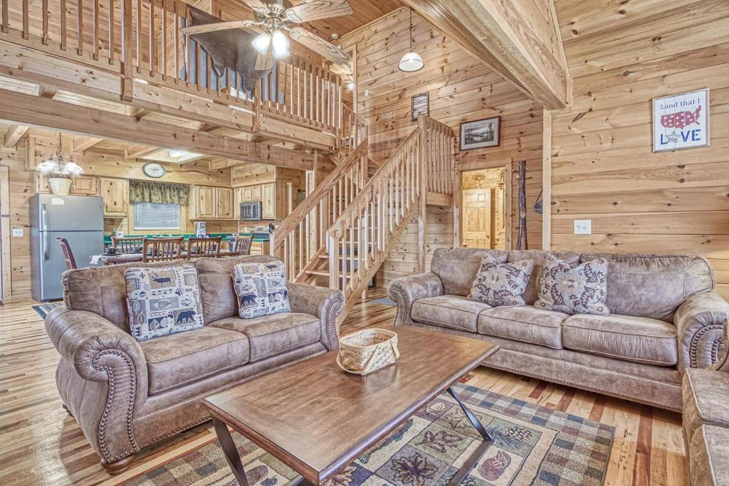 a living room with two couches and a table at Smoky Mountain Gem in Gatlinburg