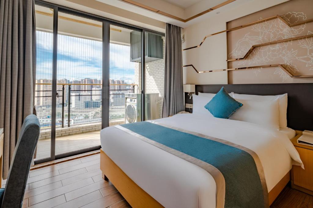 Postel nebo postele na pokoji v ubytování Dingshang Apartment Hotel