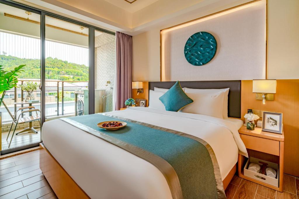 Postel nebo postele na pokoji v ubytování Dingshang Apartment Hotel