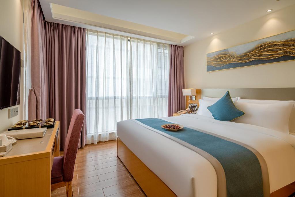 Postel nebo postele na pokoji v ubytování Dingshang Apartment Hotel