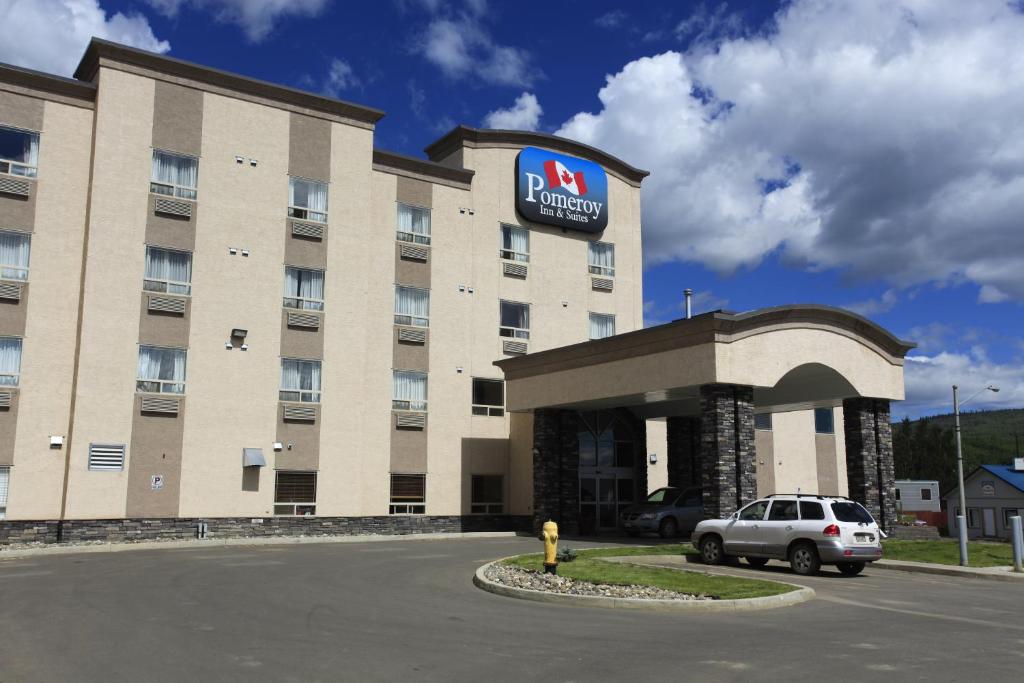 a hotel with a car parked in front of it at Pomeroy Inn and Suites Chetwynd in Chetwynd