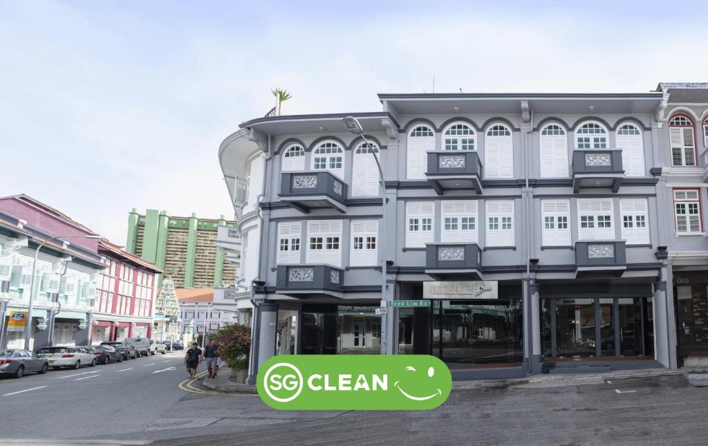 a building with a green sign in front of it at Butternut Tree Hotel in Singapore