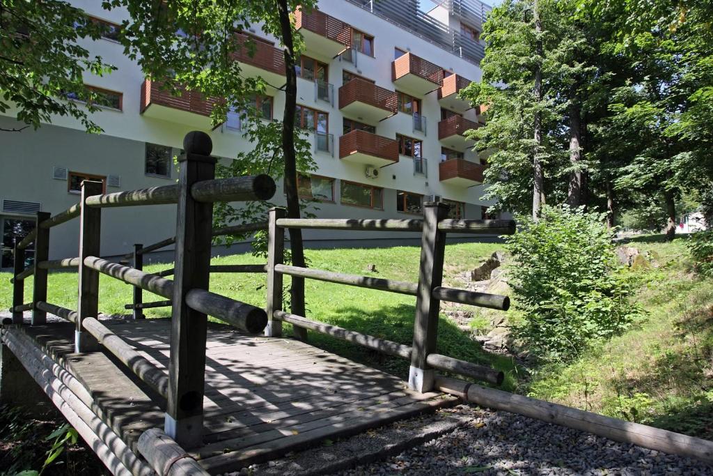 a wooden fence in front of a building at Apartmány Čeladná in Čeladná