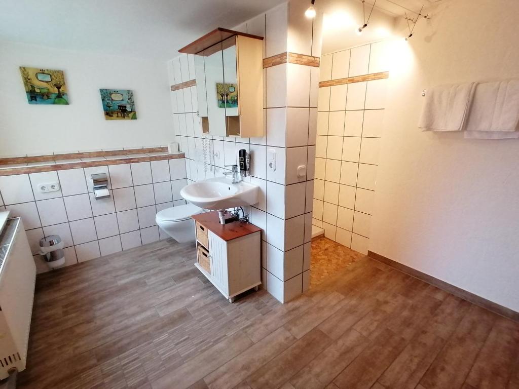 a bathroom with a sink and a toilet at Landhotel Adler in Selters