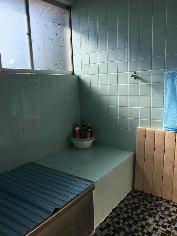Postel nebo postele na pokoji v ubytování しまなみゲストハウス南風荘