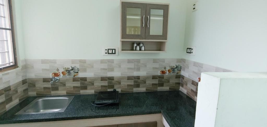 a kitchen with a sink and a counter top at MMD Residency in Thanjāvūr