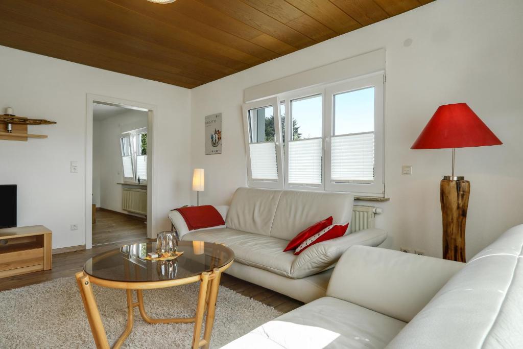 a living room with a couch and a table at Ferienwohnung Eberle in Eriskirch