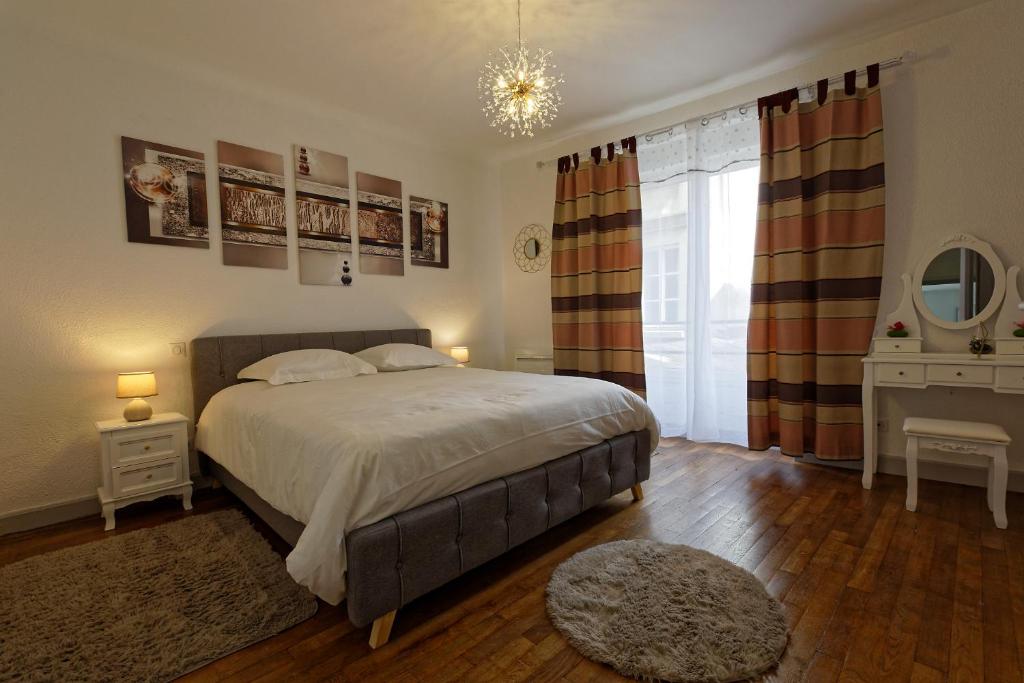 1 dormitorio con cama, escritorio y ventana en Le cocon d'Eloïse en Verdun