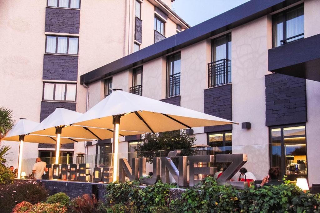 a group of umbrellas in front of a building at Hotel Torre de Núñez in Lugo