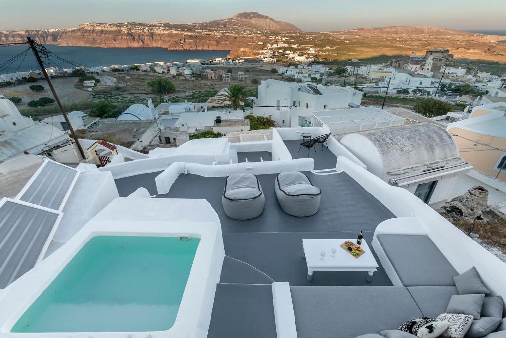 a balcony with a pool and a table and chairs at I-Sol in Akrotiri