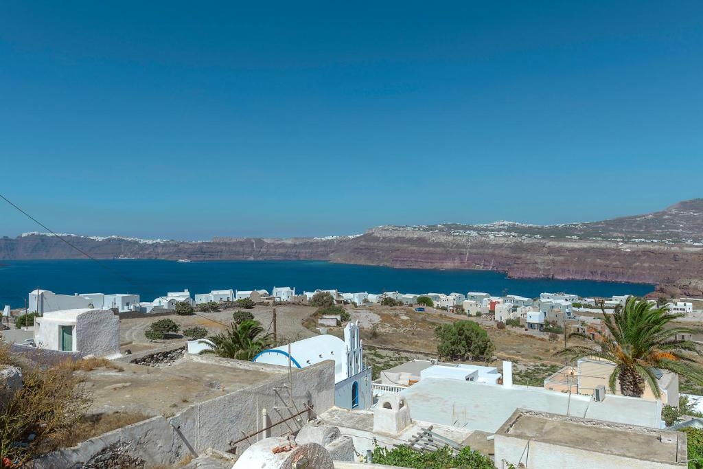 a view of a city and a body of water at Antron Cave House in Akrotiri