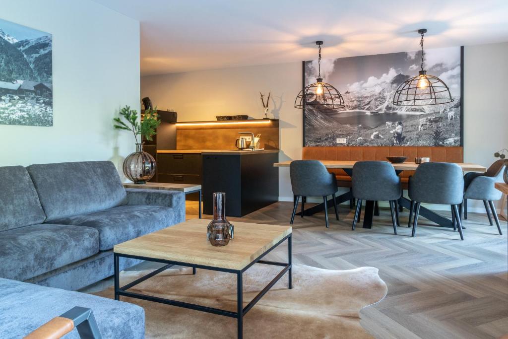 a living room with a couch and a table at UplandParcs Montafon in Sankt Gallenkirch