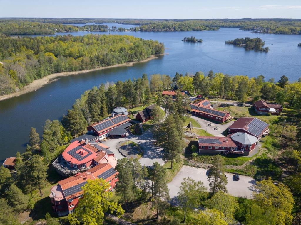 an aerial view of a house on the shore of a lake at Stiftsgården Vårdnäs Hotell in Brokind