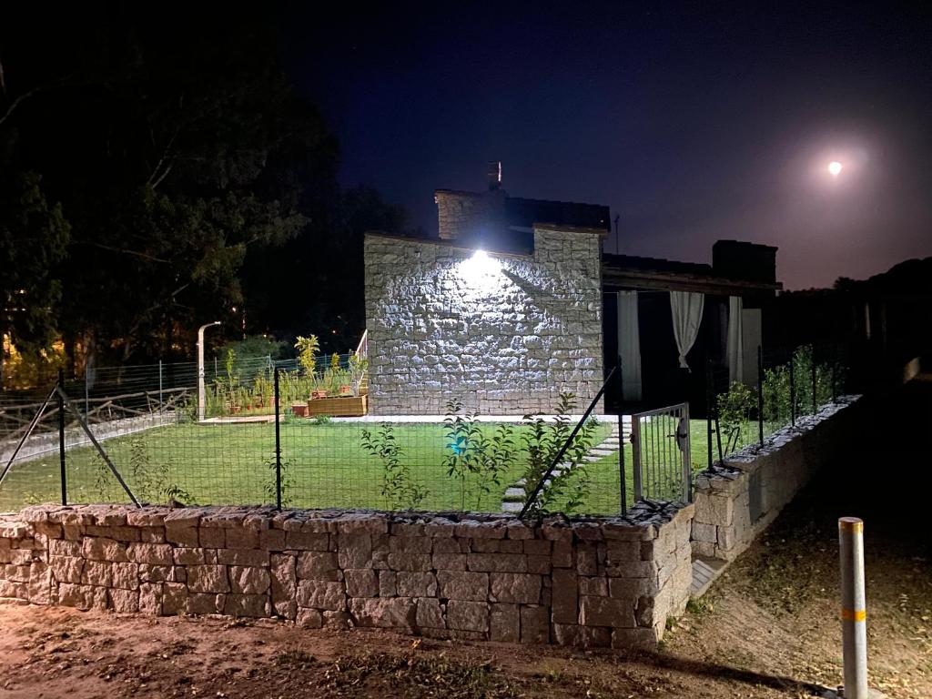a stone building with a light on it at night at Villa Ibiscus Cala Sinzias in Castiadas
