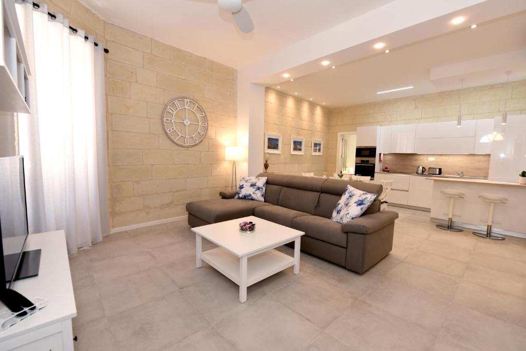 a living room with a couch and a table at Luxury Maisonette in Vittoriosa