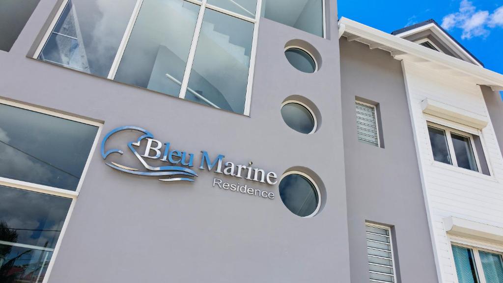 a building with a sign on the side of it at Residence Bleu Marine - Honeymoon apartments in Saint Martin