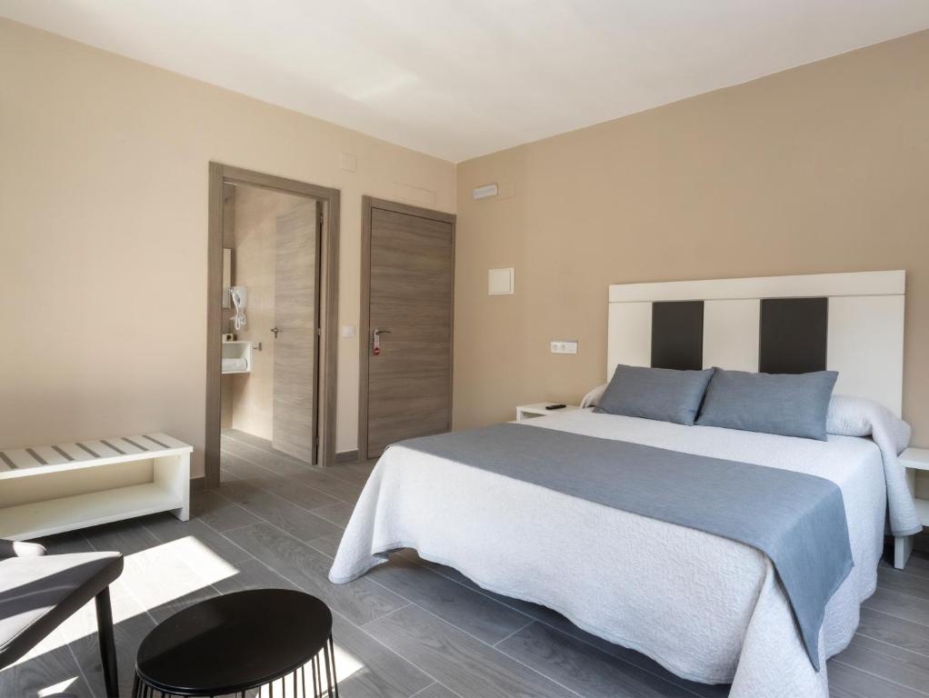 Postel nebo postele na pokoji v ubytování Hotel Querol