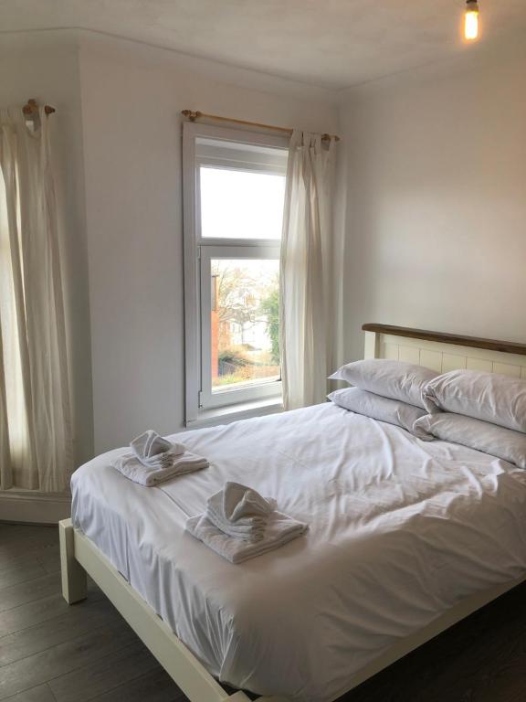 a bedroom with a bed with two towels on it at The Grey Town House in Newport