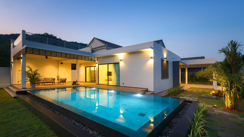 a house with a swimming pool in front of it at Sivana Villas Hua Hin in Hua Hin