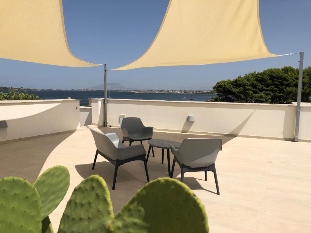 a patio with a table and chairs and cactus at Ca' del Sale 97 in Marsala