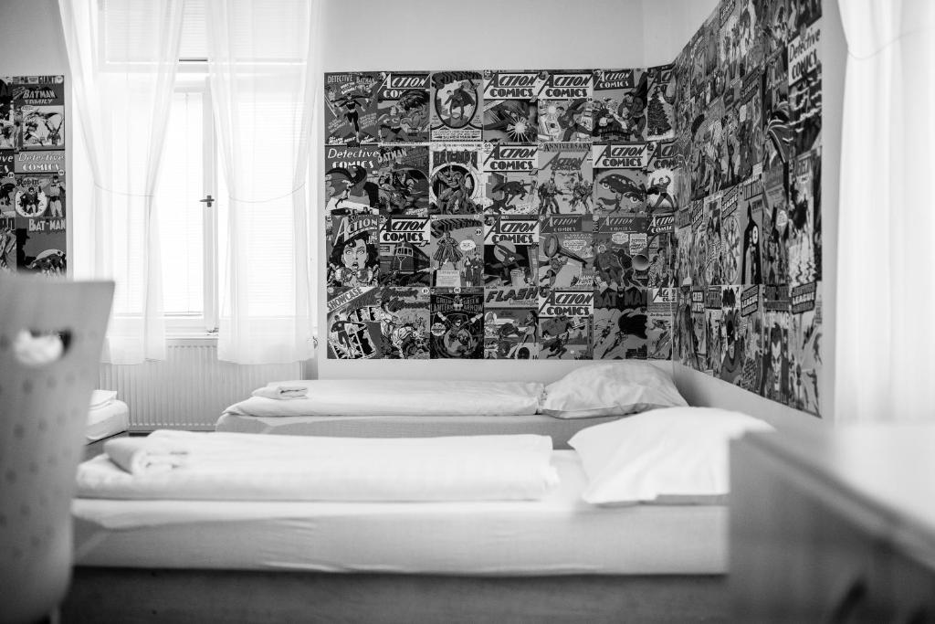 a living room with a bed and a painting on the wall at Hostel Florenc in Prague