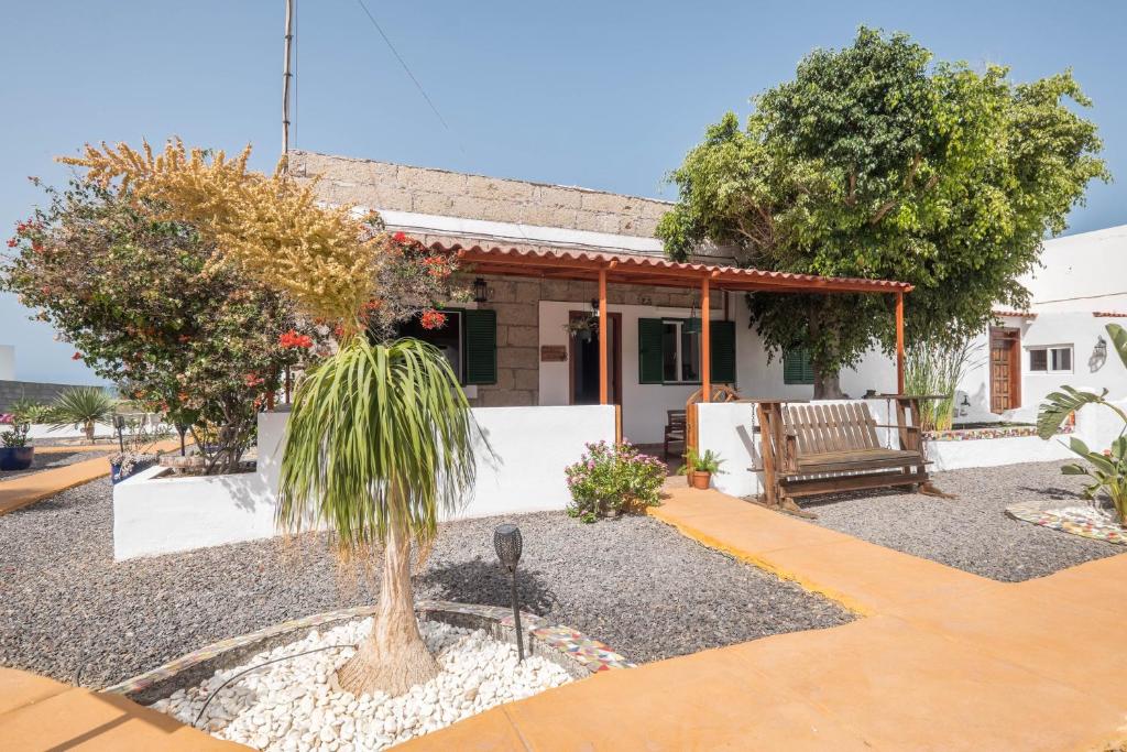 una casa con una palma di fronte di Casa Verode - Villa Perenquén a Guía de Isora