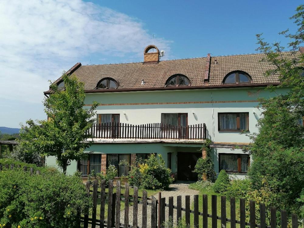 a large house with a fence in front of it at Otevřená Náruč Pension in Letovice