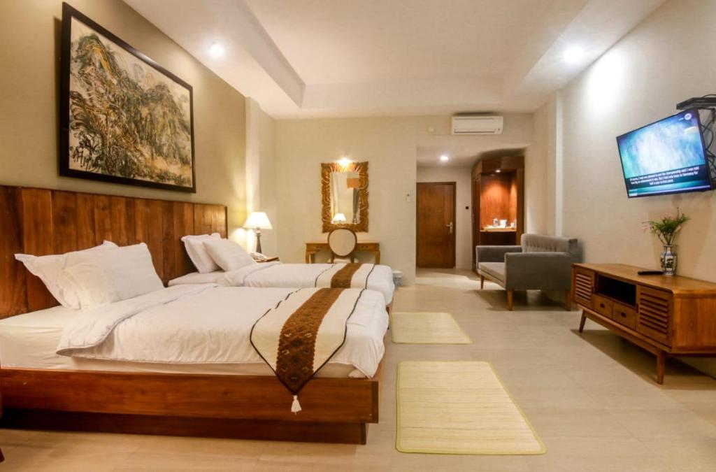 Postel nebo postele na pokoji v ubytování Khanaya Hotel Borobudur