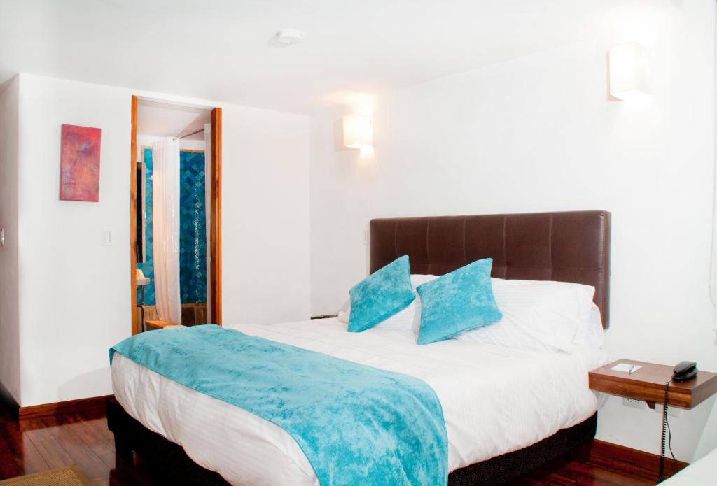 Postel nebo postele na pokoji v ubytování Hotel Casona Usaquen