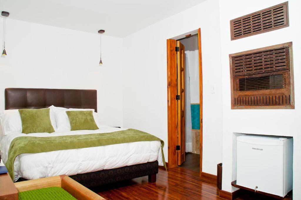 Postel nebo postele na pokoji v ubytování Hotel Casona Usaquen