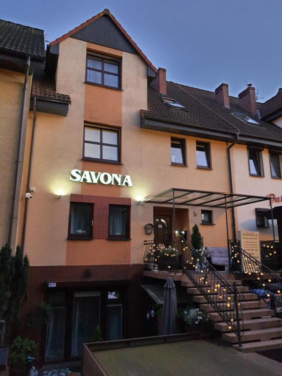 a building with a sign that reads savenonia at Savona Świnoujście in Świnoujście