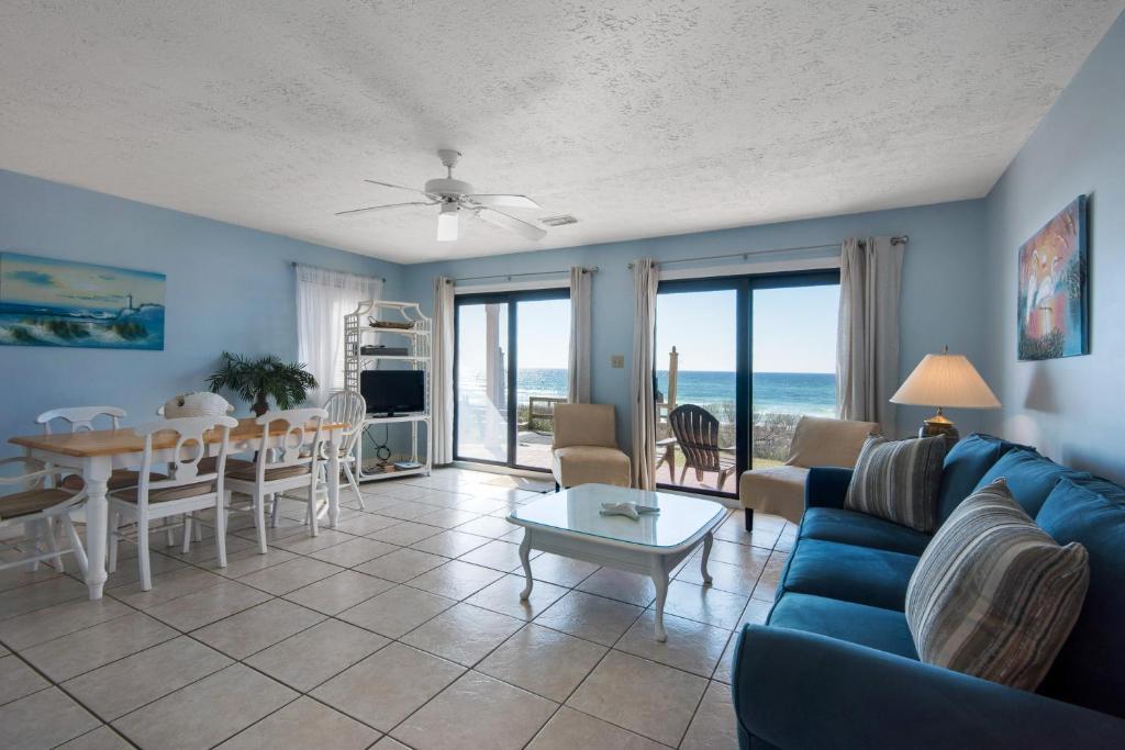a living room with a blue couch and a table at Crystal Villas in Destin