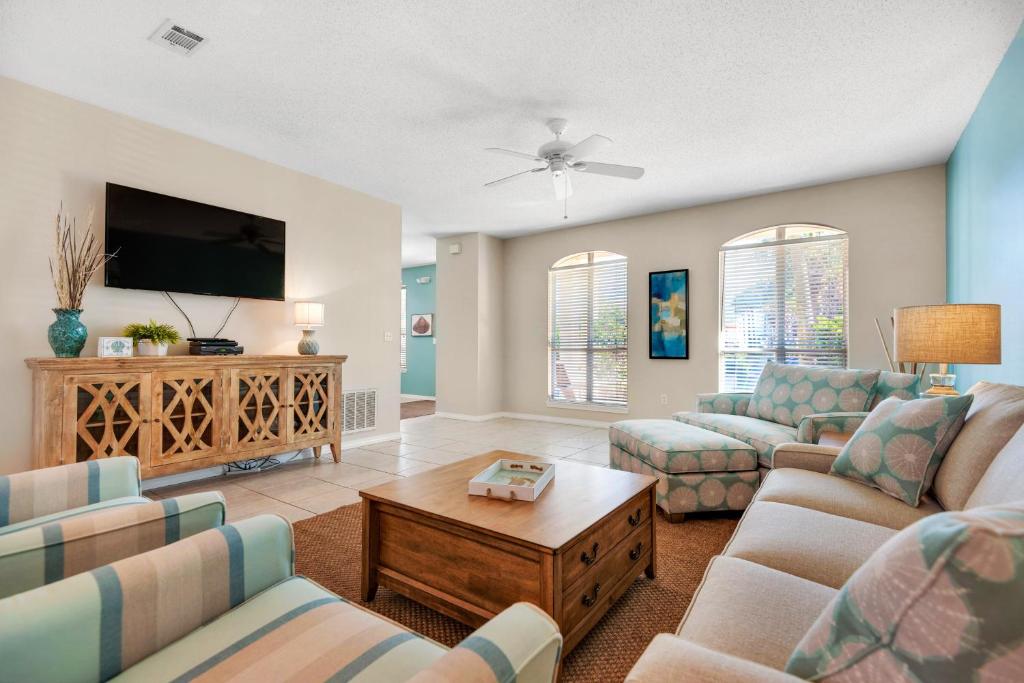 a living room with two couches and a flat screen tv at Emerald Shores in Destin