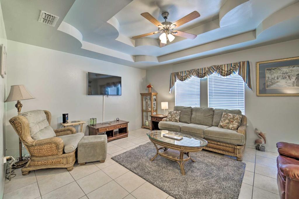 a living room with a couch and a table at Long Island Village Escape with Deck and Pool Access! in Port Isabel