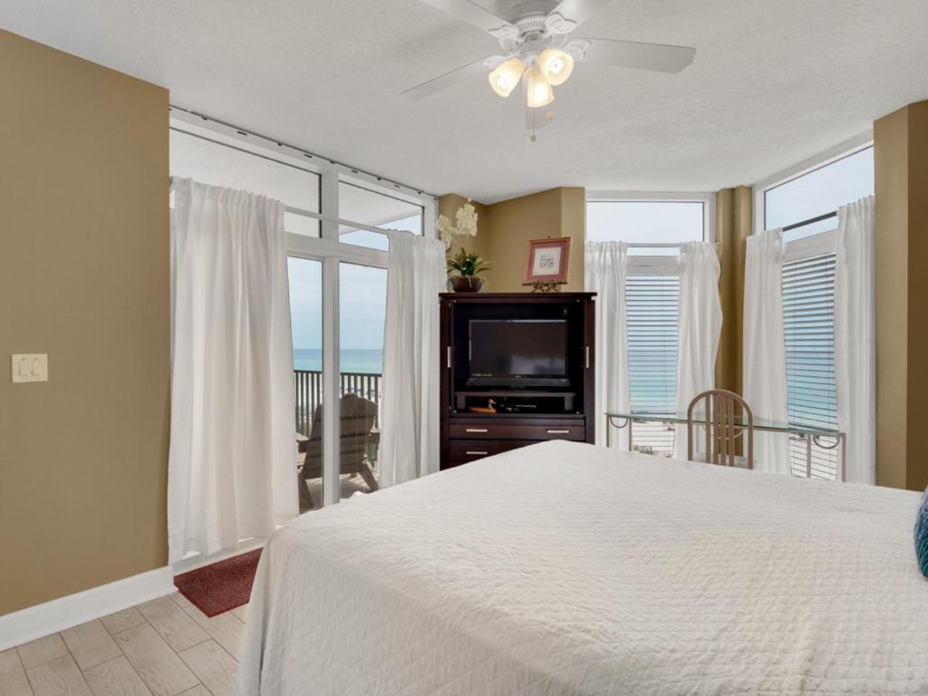 a bedroom with a bed and a flat screen tv at Jade East Condominiums in Destin
