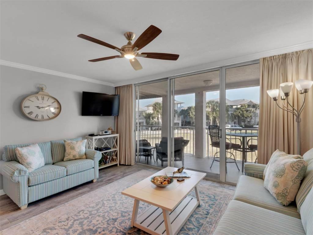 a living room with a couch and a table at Magnolia House at Destin Pointe I in Destin