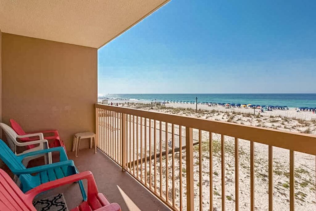 a balcony with beach chairs and the ocean at Pelican Beach Resort in Destin