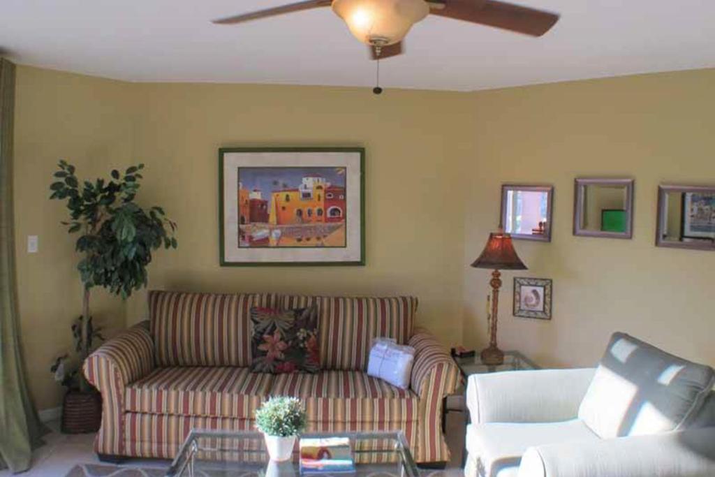 a living room with a couch and a ceiling fan at Gulfview Condominiums in Destin