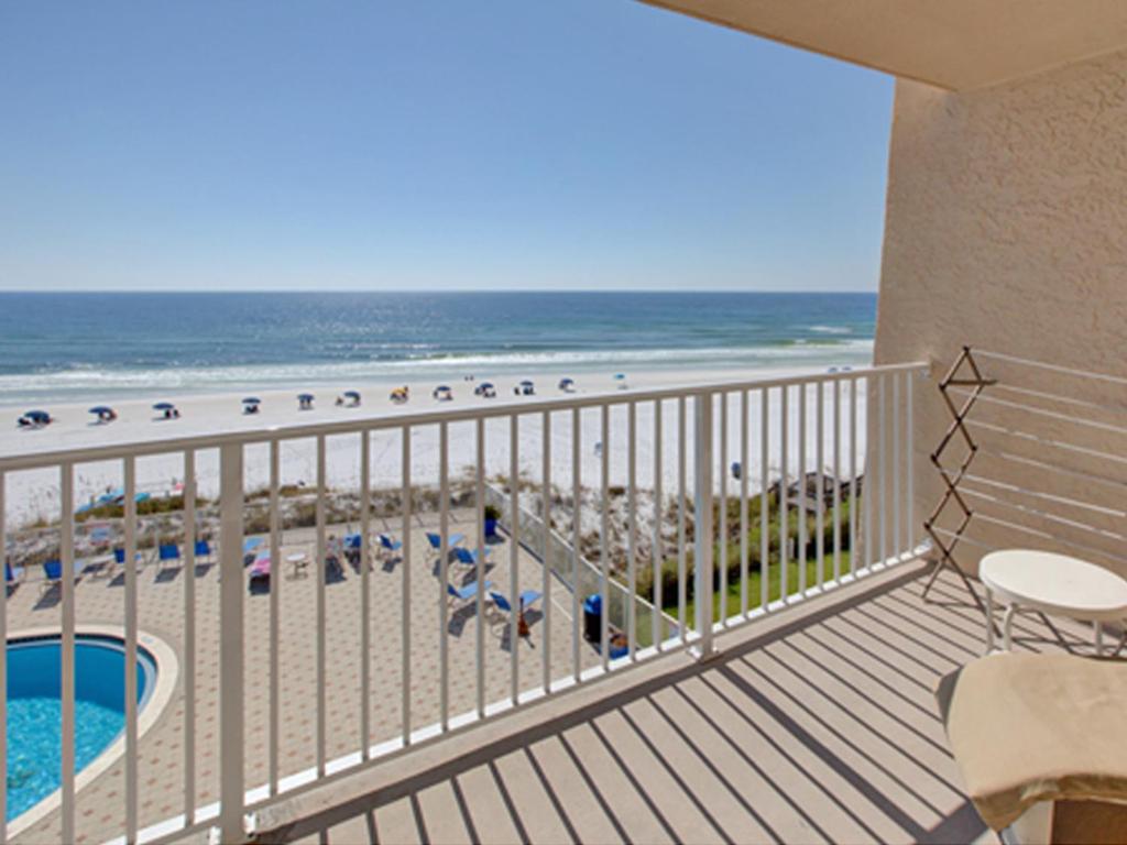 a balcony with a view of the beach and the ocean at Beach House IV in Destin