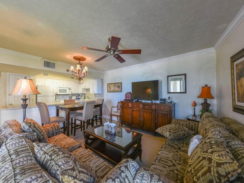 a living room with couches and a dining room at Mainsail II in Destin