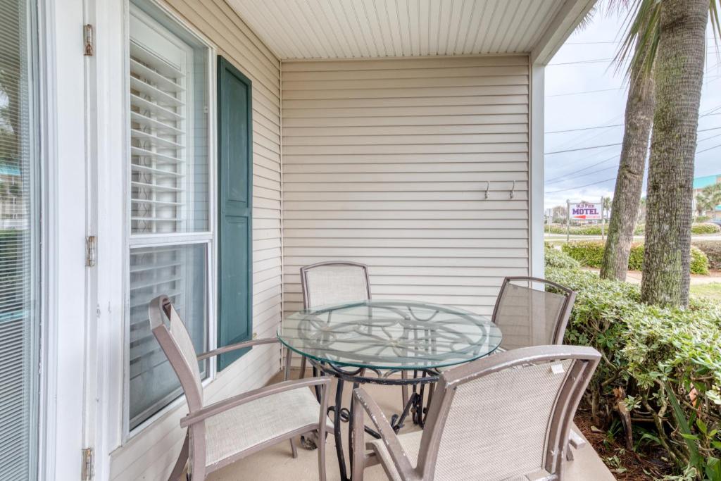 a patio with a glass table and chairs on a porch at Grand Caribbean West in Destin