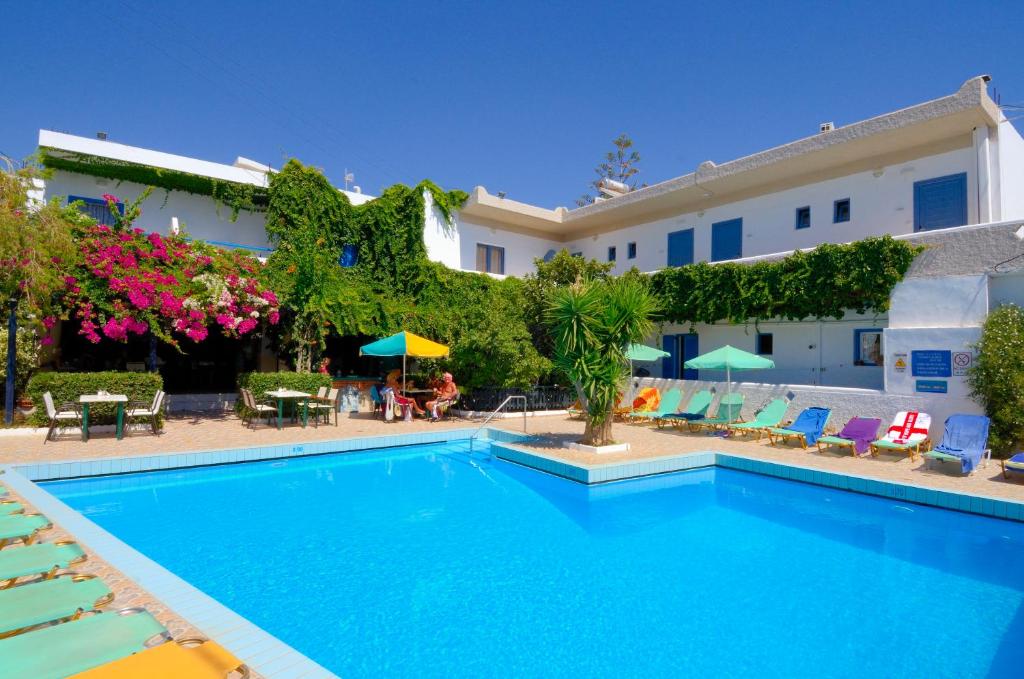 a swimming pool in front of a building at Costas & Chrysoula in Plakias