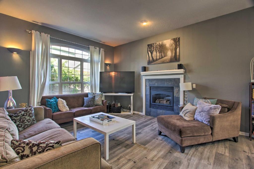 a living room with two couches and a fireplace at Pet-Friendly Home with Grill, 2 Mi to Autzen Stadium! in Springfield