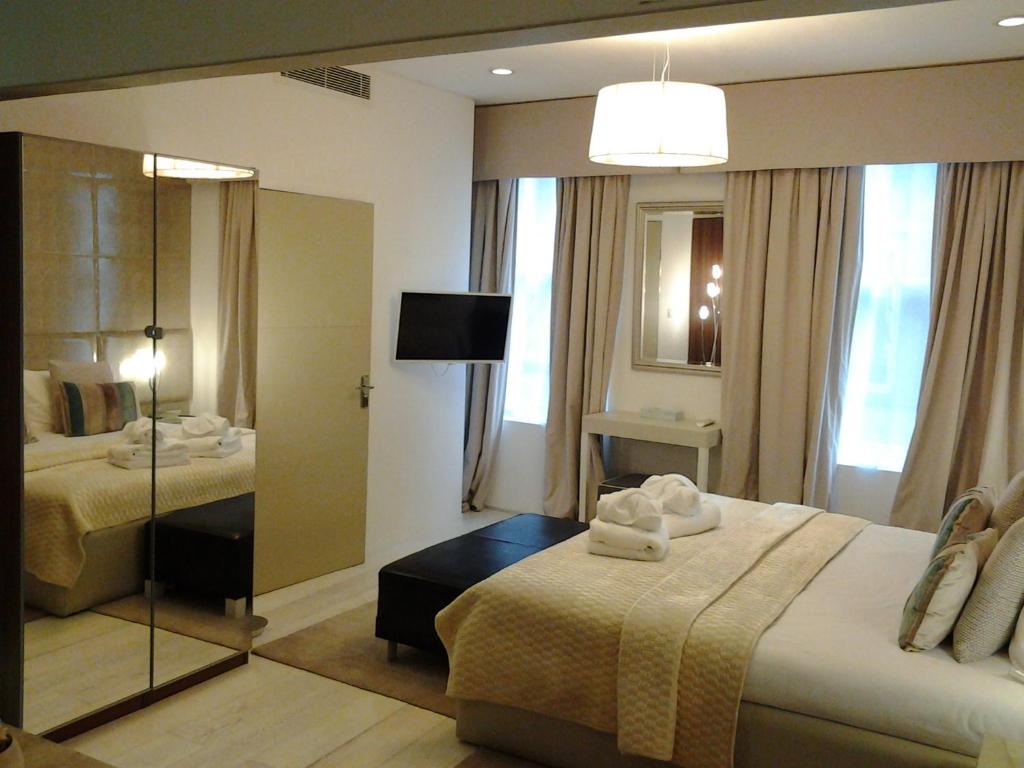 a hotel room with two beds and a mirror at Room Home Stay in London