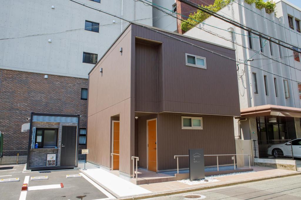 un edificio en la esquina de una calle en HOTEL&CO, en Fukuoka