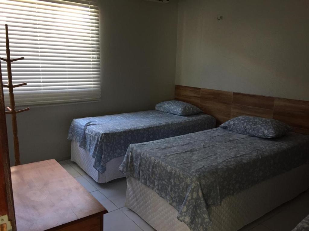 En eller flere senge i et værelse på Casa de praia Luís Correia