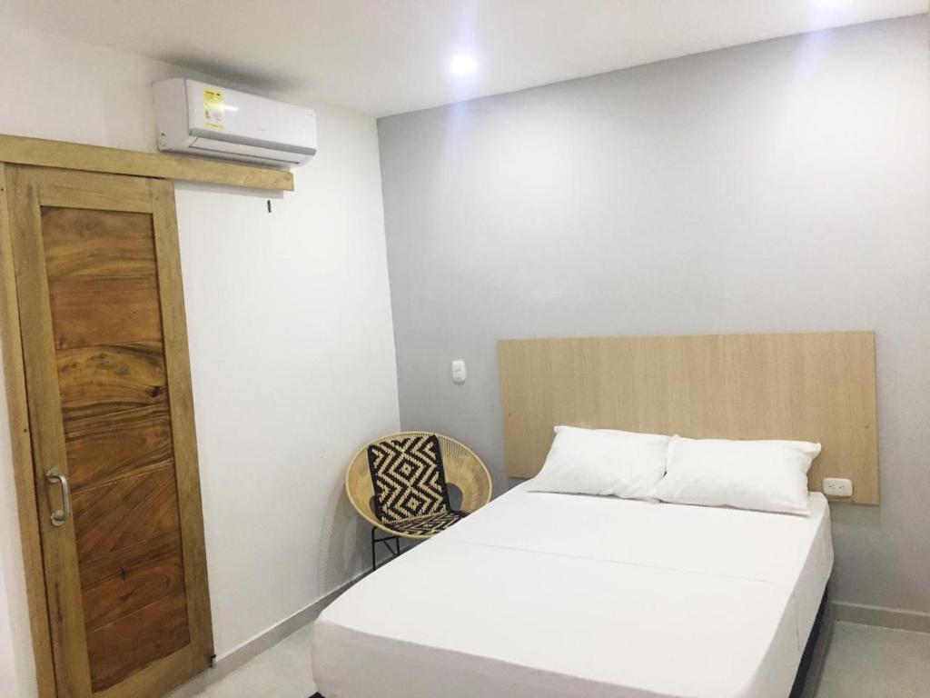 Postel nebo postele na pokoji v ubytování Stanza Hotel Sincelejo