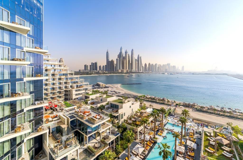 an aerial view of the beach and the city at Luxury Apartment in Dubai's hottest Palm hotel in Dubai